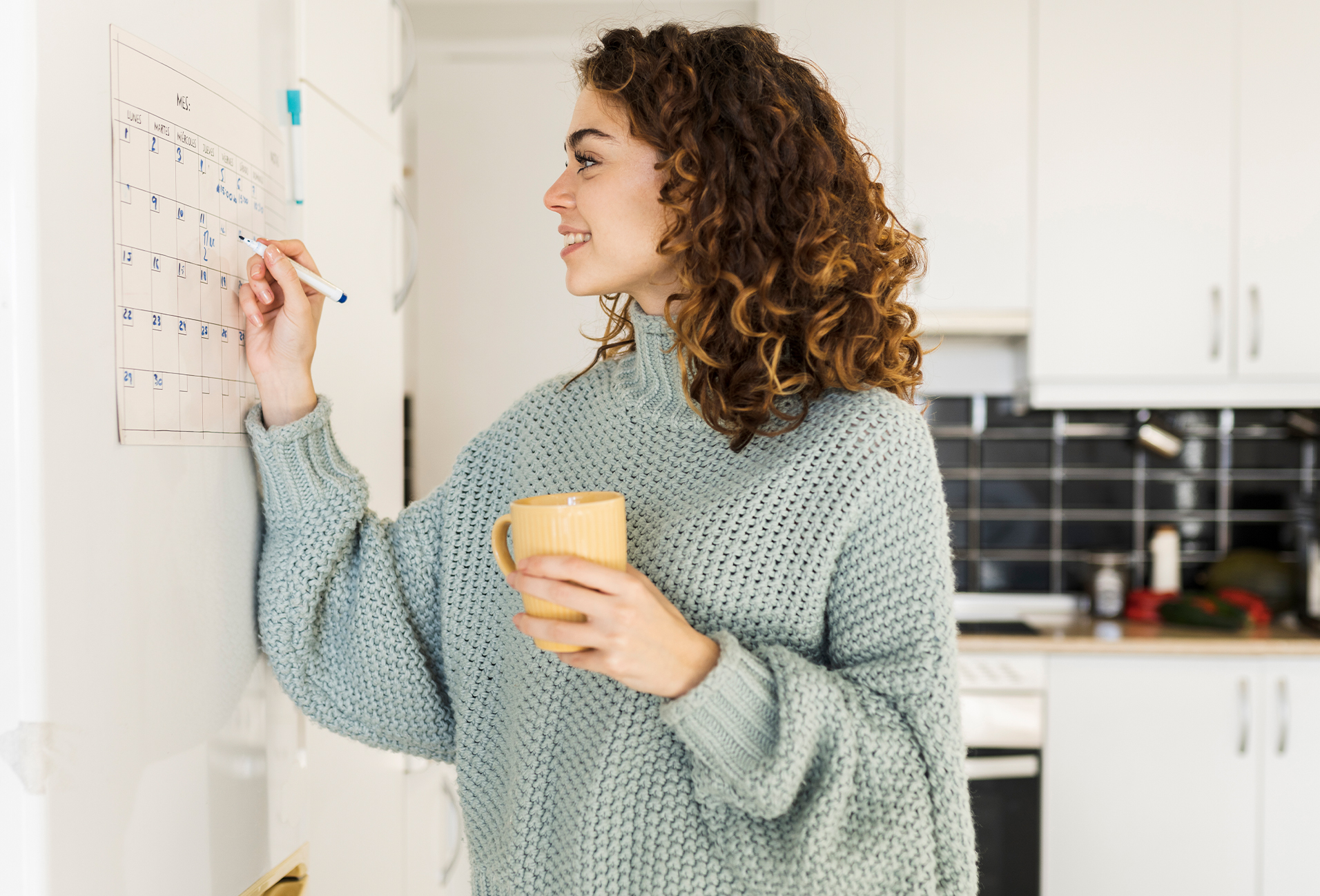 woman writing on a calendar