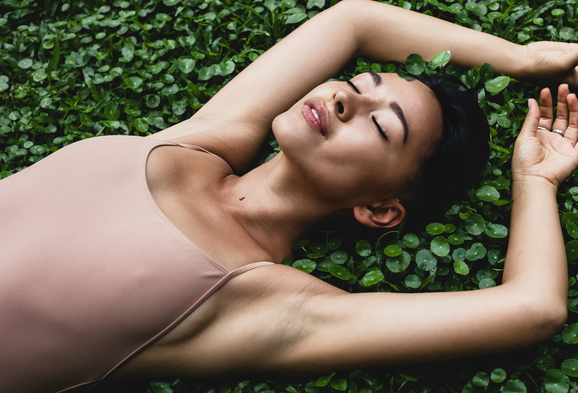 woman laying on the ground with her eyes closed