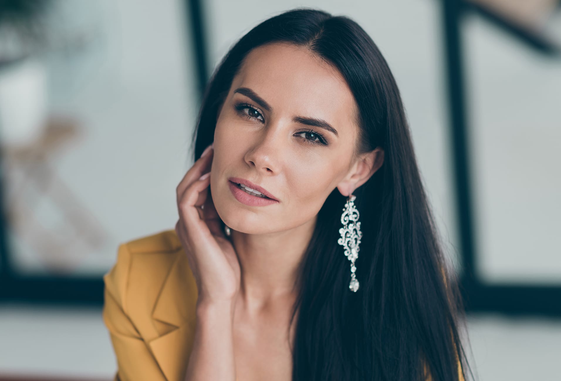 woman with long dark hair wearing big earrings