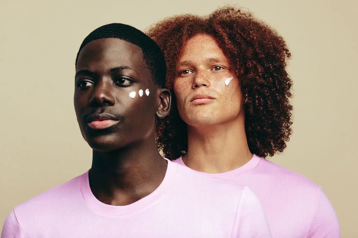 Two men with varying skin tones posing and looking away from camera