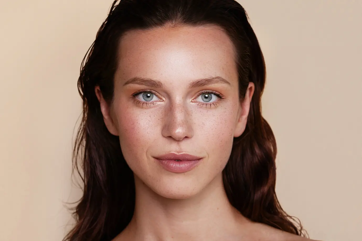 Woman with hazel eyes staring forward with faint smile